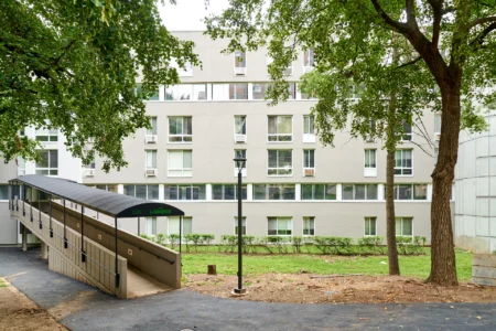 Covered pedestrian ramp leading through a landscaped courtyard at The Landings.