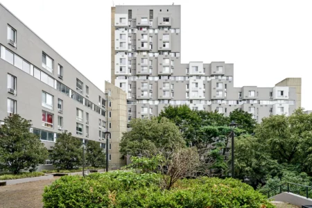The Landings apartment buildings overlooking a planted courtyard with shrubs and mature trees.